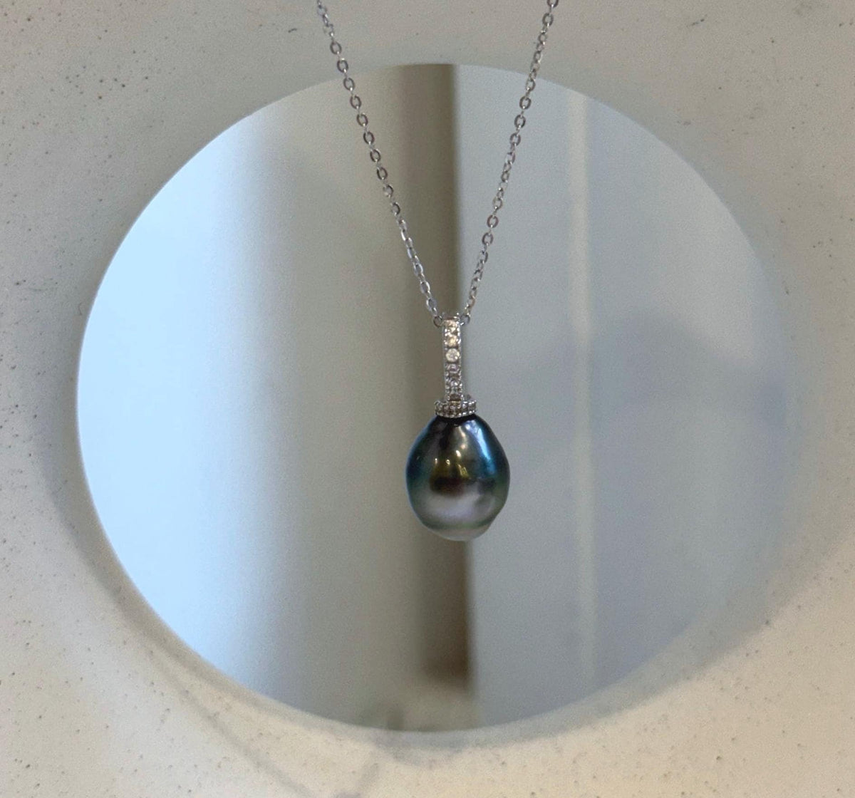 Genuine Tahitian pearl pendant with sparkling crystal accents and sterling silver detailing.