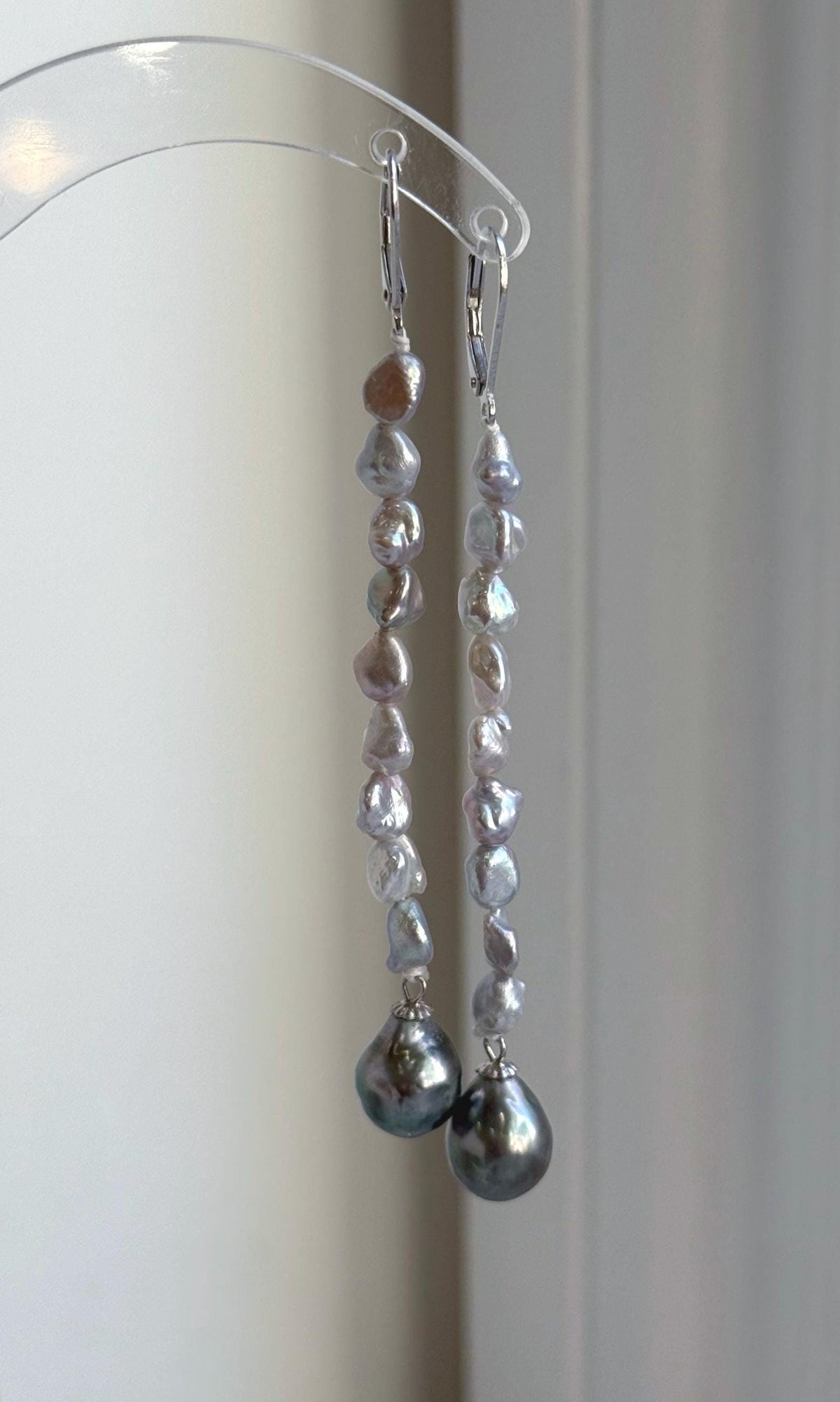 Tahitian pearl drop earrings with reflective green tones and leverback fastenings.