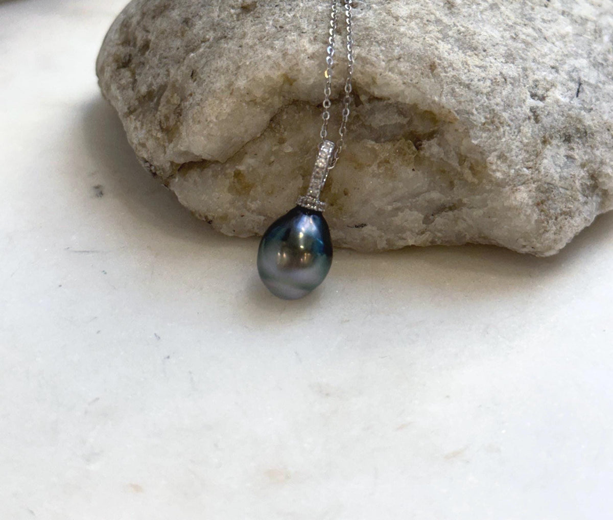 Crystal-accented sterling silver pendant featuring a lustrous Tahitian pearl.