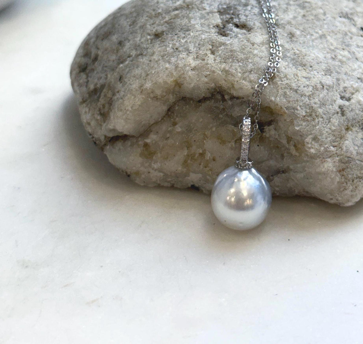 White pearl pendant combining reflective South Sea pearl luster with sterling silver.