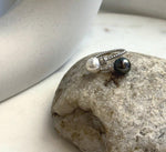 Tahitian and freshwater pearls paired in a simple adjustable silver ring.