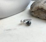Adjustable double pearl ring combining Tahitian and freshwater pearls with mirror luster.