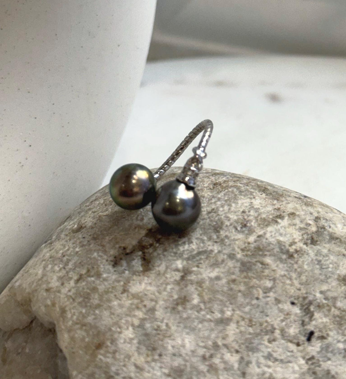 Two lustrous Tahitian saltwater pearls paired in a simple adjustable silver ring.