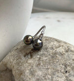 Two lustrous Tahitian saltwater pearls paired in a simple adjustable silver ring.