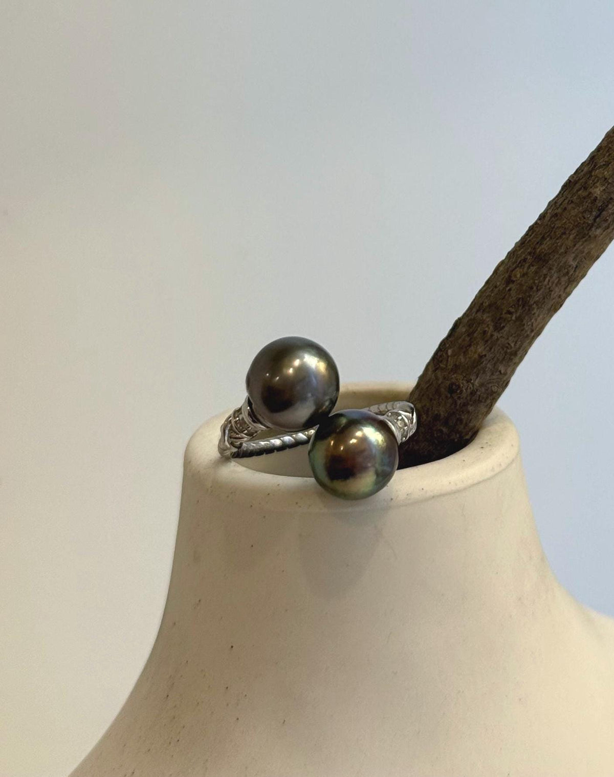 Double pearl ring combining reflective Tahitian pearls with a minimalist sterling silver design.