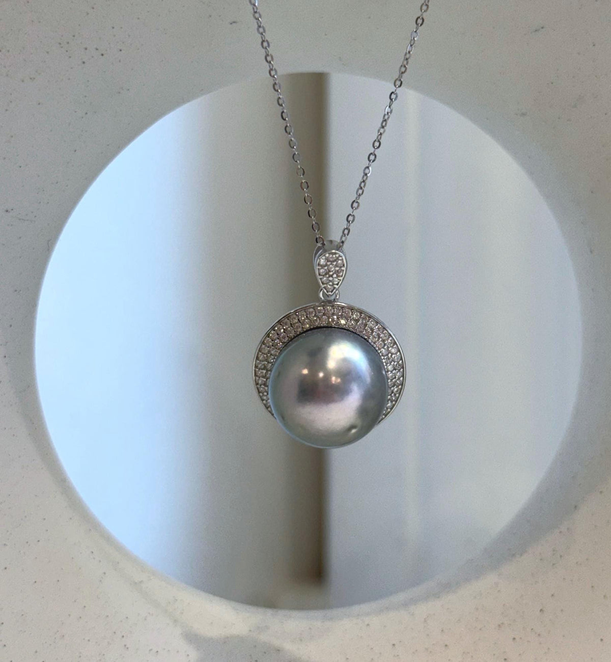 S925 sterling silver pendant showcasing a silver-blue Tahitian pearl surrounded by sparkling clear stones.