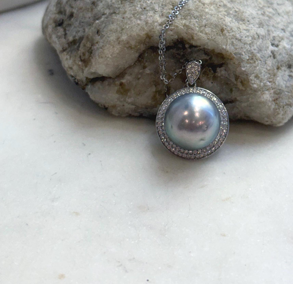 Large pearl statement necklace with a crystal-accented halo and matching silver bail.