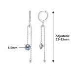 Long silver earrings featuring 6.5mm round moissanite center stones