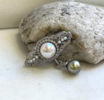 Edison pearl brooch pendant with a luminous white center pearl and dark pearl drop