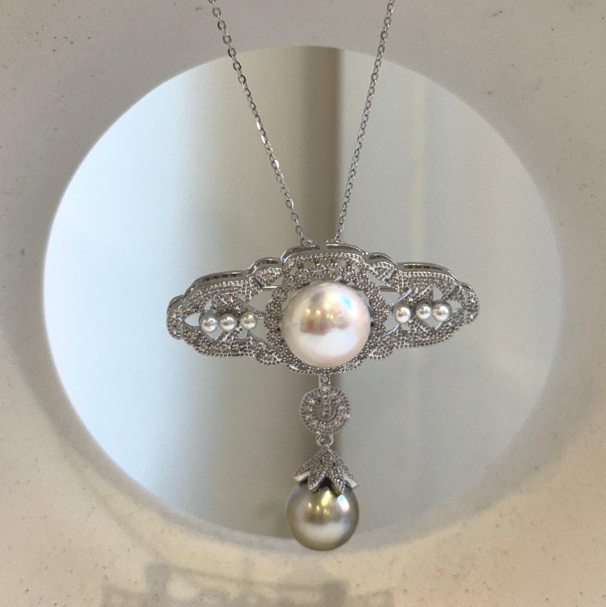 Two-in-one pearl brooch and pendant with vintage-inspired silver-tone detailing