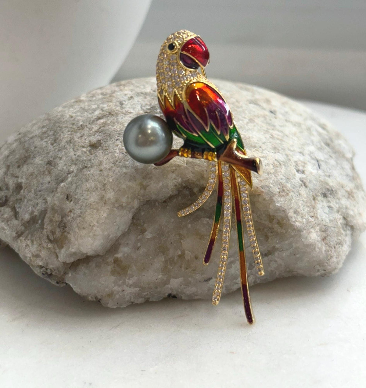 Multicolor enamel parrot brooch pendant pairing a genuine Tahitian pearl with a gold-tone setting.