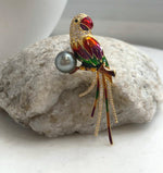 Multicolor enamel parrot brooch pendant pairing a genuine Tahitian pearl with a gold-tone setting.