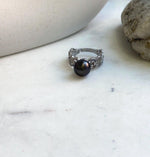 Close-up of a black platinum Tahitian pearl on a gold-plated sterling silver ring