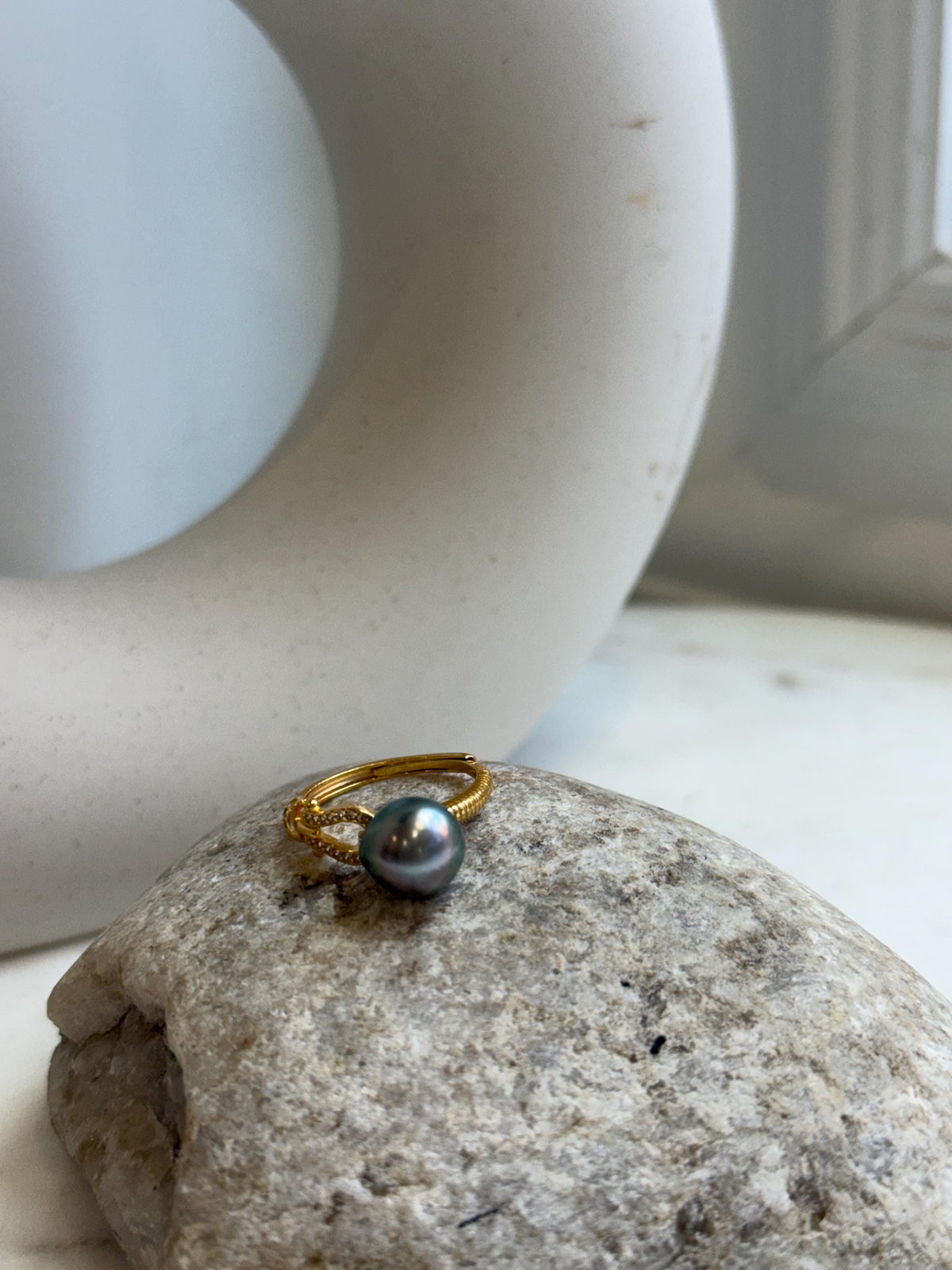Peacock green Tahitian pearl ring shown beside its handwritten size label