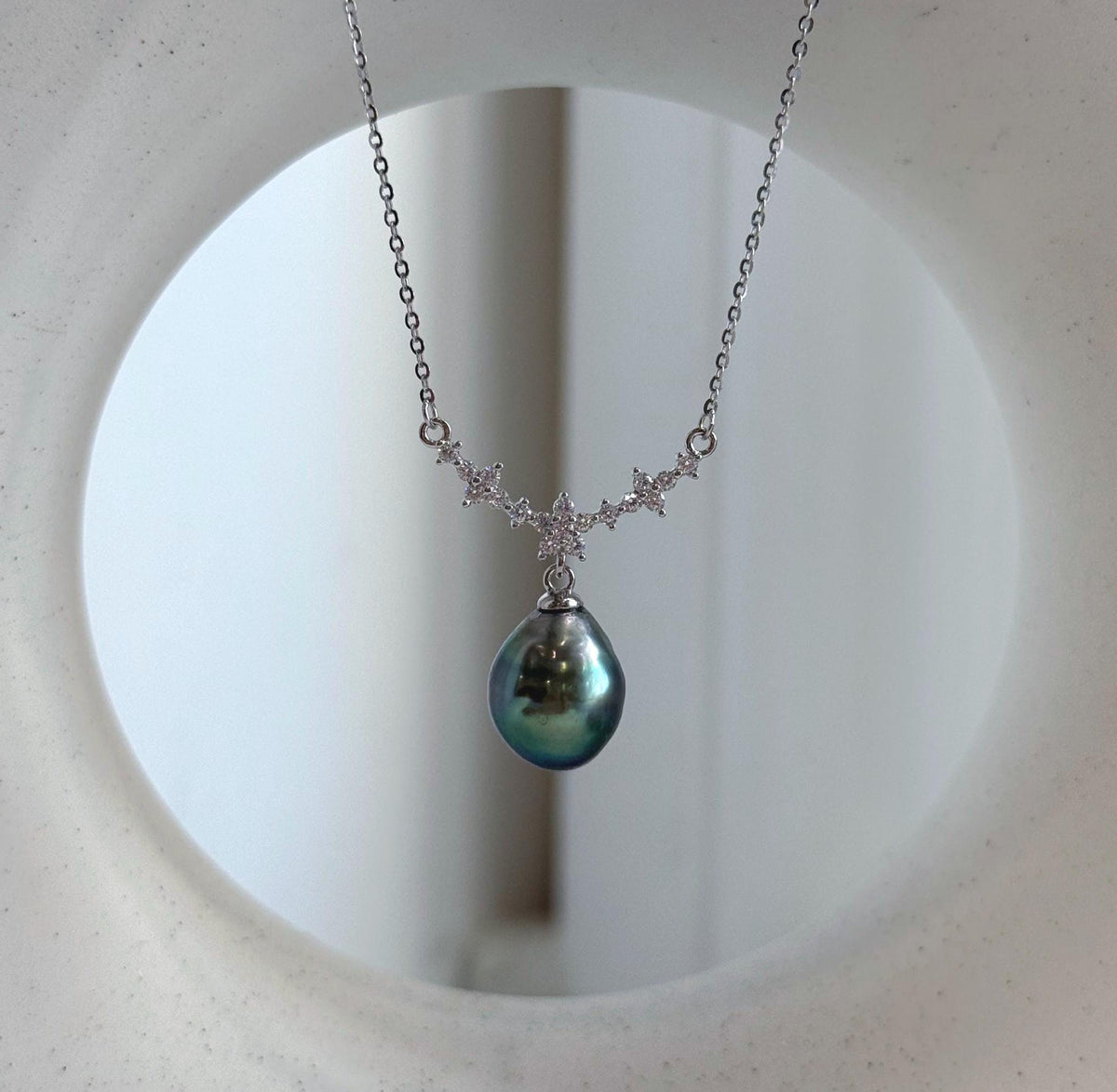 Peacock green pearl necklace featuring a floral centerpiece and a fine S925 sterling silver chain.