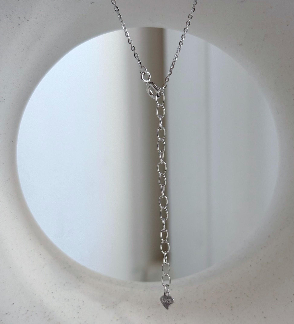 Lustrous drop-shaped Tahitian pearl paired with clear stone accents and S925 sterling silver.