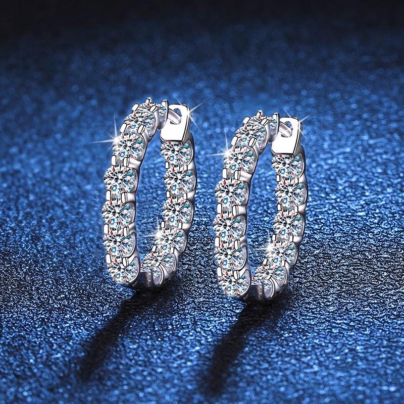 Moissanite hoop earrings with 13 round stones on each hoop.