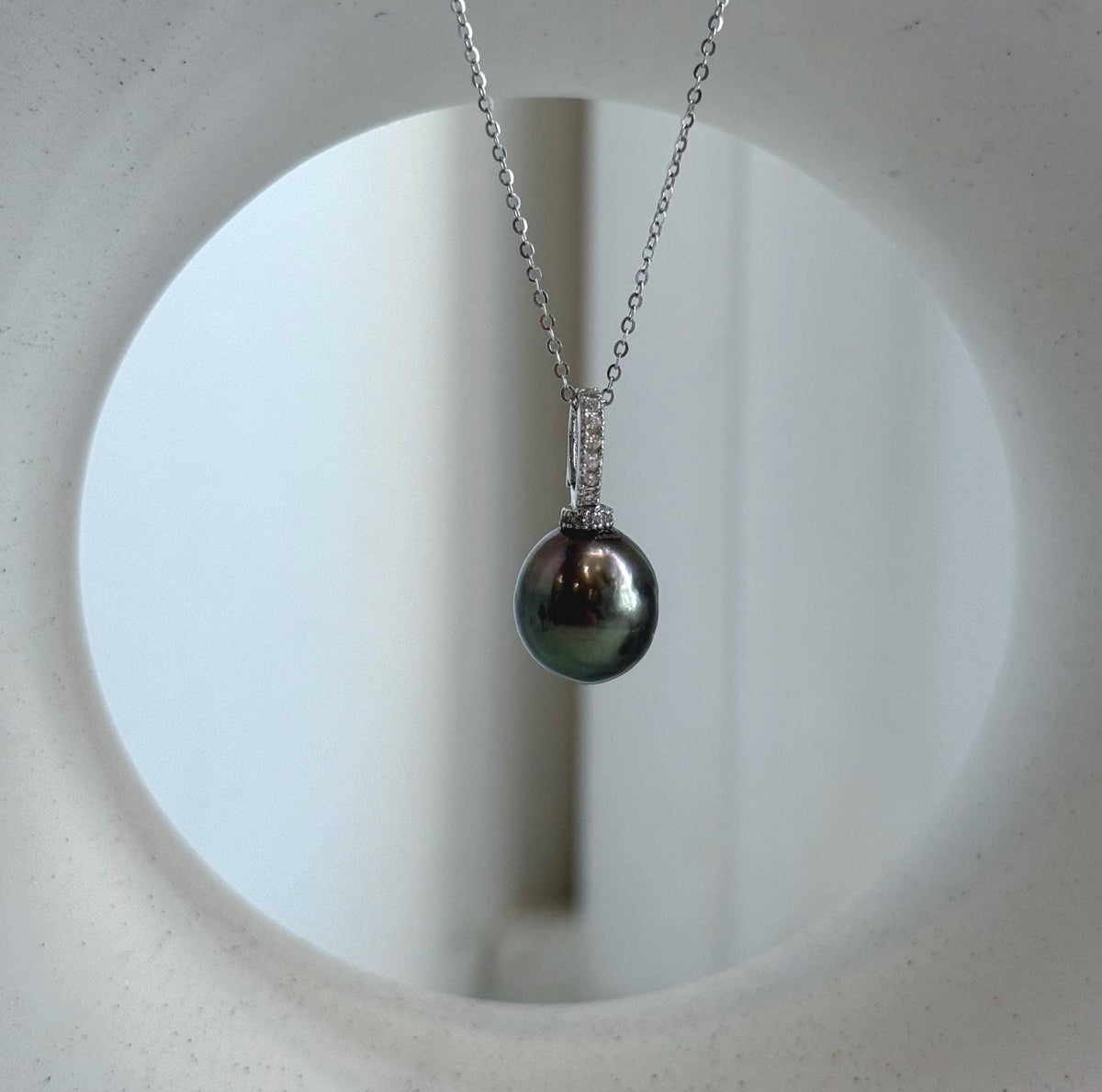 Genuine saltwater Tahitian pearl in a peacock green shade, set in crystal-accented sterling silver.