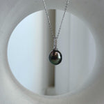 Genuine saltwater Tahitian pearl in a peacock green shade, set in crystal-accented sterling silver.