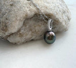 Genuine saltwater Tahitian pearl in a peacock green shade, set in crystal-accented sterling silver.