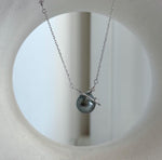 Genuine saltwater pearl necklace featuring a planet design with small star accents and a fine silver chain.