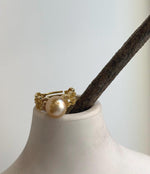 Elly’s ring featuring a 10.2mm deep tea-gold South Sea pearl on an adjustable gold-plated S925 silver band with lace detailing.