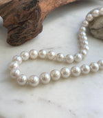 White Edison pearl strand with a lustrous finish and sterling silver clasp.