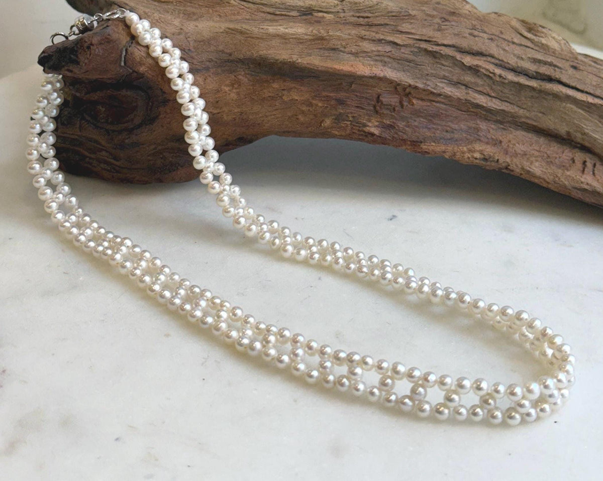 Lustrous white pearls arranged in an open lace pattern.