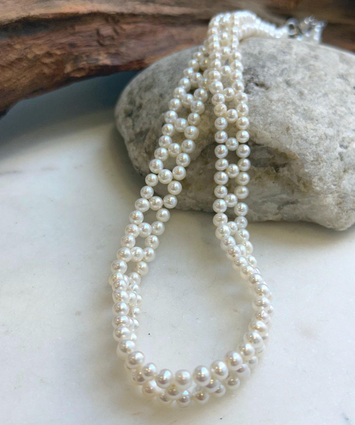 Woven pearl necklace featuring a delicate repeating diamond pattern.