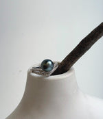 Green Tahitian pearl ring with two rows of clear accents along the shoulders.