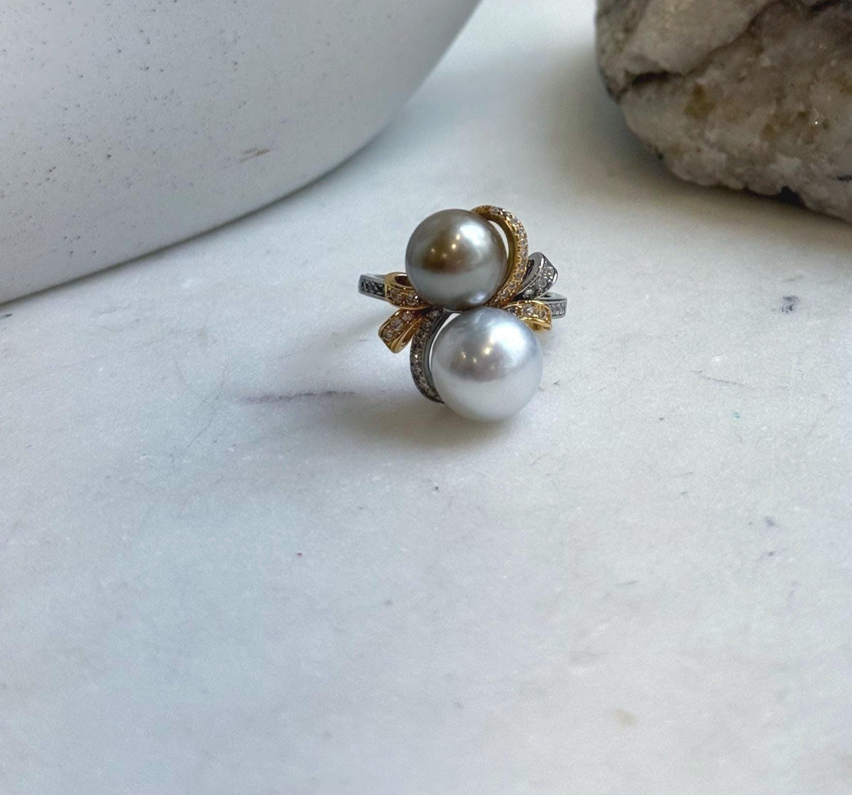 Silver taupe Tahitian pearl ring with delicate floral details.