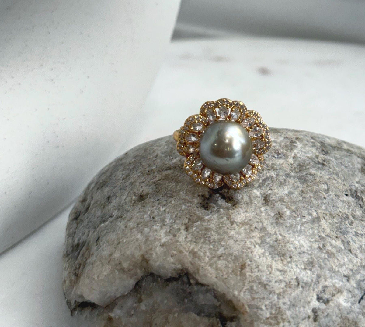 Taupe saltwater pearl paired with a flower-inspired gold-plated silver setting.