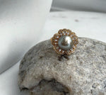 Taupe saltwater pearl paired with a flower-inspired gold-plated silver setting.