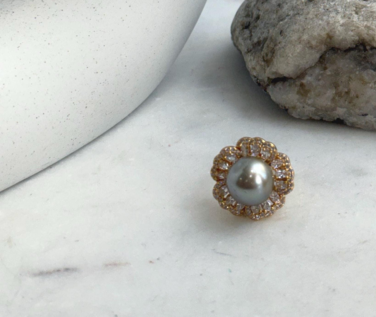 Reflective taupe Tahitian pearl set in a gold-plated sterling silver flower ring.