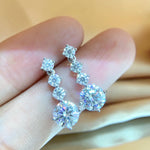 Moissanite earrings featuring eight D-color, VVS1-clarity stones totaling 2.6 carats.