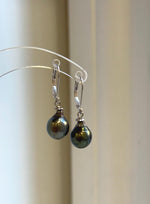 Lustrous peacock green Tahitian pearls suspended from S925 silver leverback closures.