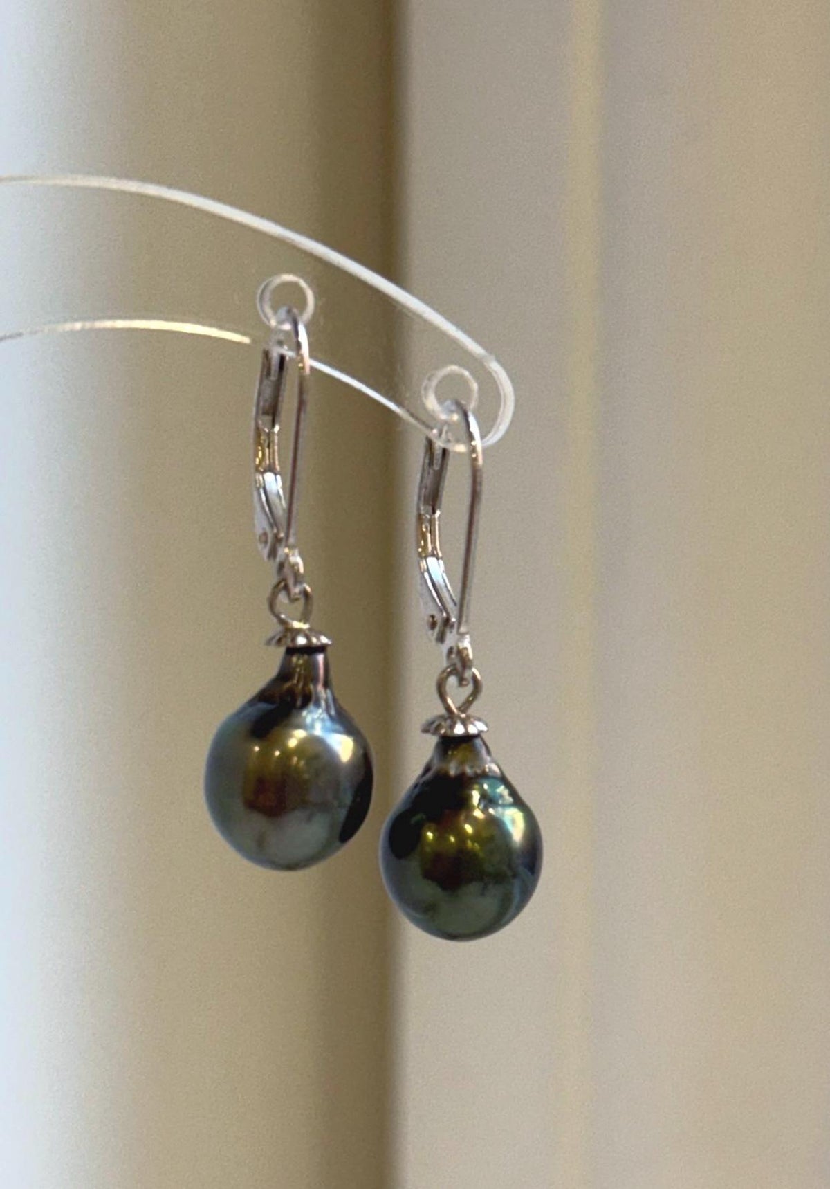 Tahitian pearl earrings pairing deep hunter green tones with sterling silver settings.