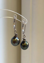 Tahitian pearl earrings pairing deep hunter green tones with sterling silver settings.