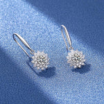 Floral moissanite earrings with polished silver hooks and delicate dangling settings.