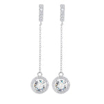 Round brilliant-cut moissanite centers surrounded by small sparkling stones on silver chain earrings.