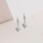 S925 sterling silver drop earrings with prong-set moissanite centers and circular connecting links.