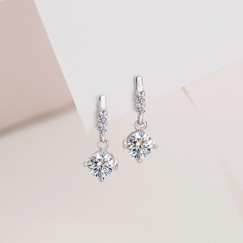 S925 sterling silver drop earrings with prong-set moissanite centers and circular connecting links.