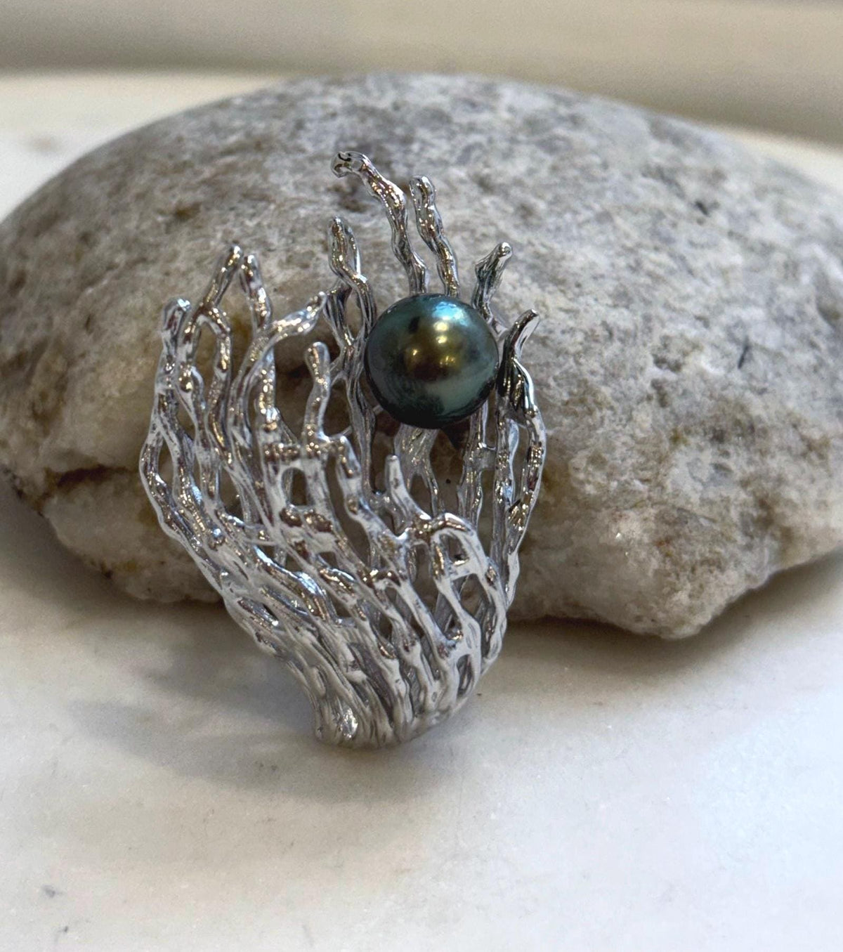 Peacock green Tahitian pearl brooch and pendant with a sculptural 3D coral design.