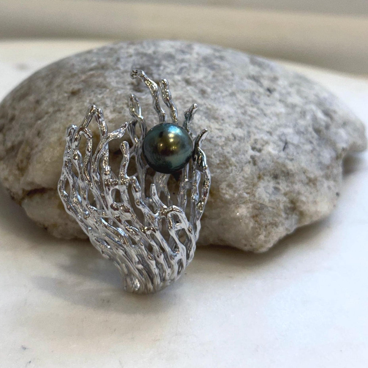 Genuine Tahitian saltwater pearl set within an intricate coral-inspired jewelry design.