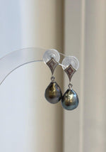 Teardrop Tahitian pearl earrings showing green, blue and bronze overtones.
