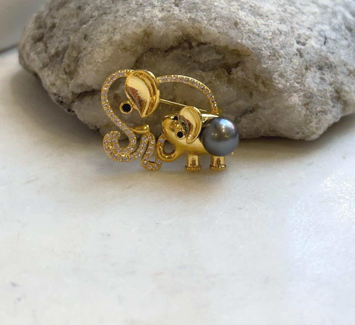 Gold-tone elephant brooch pendant with sparkling clear accents and a genuine saltwater pearl.
