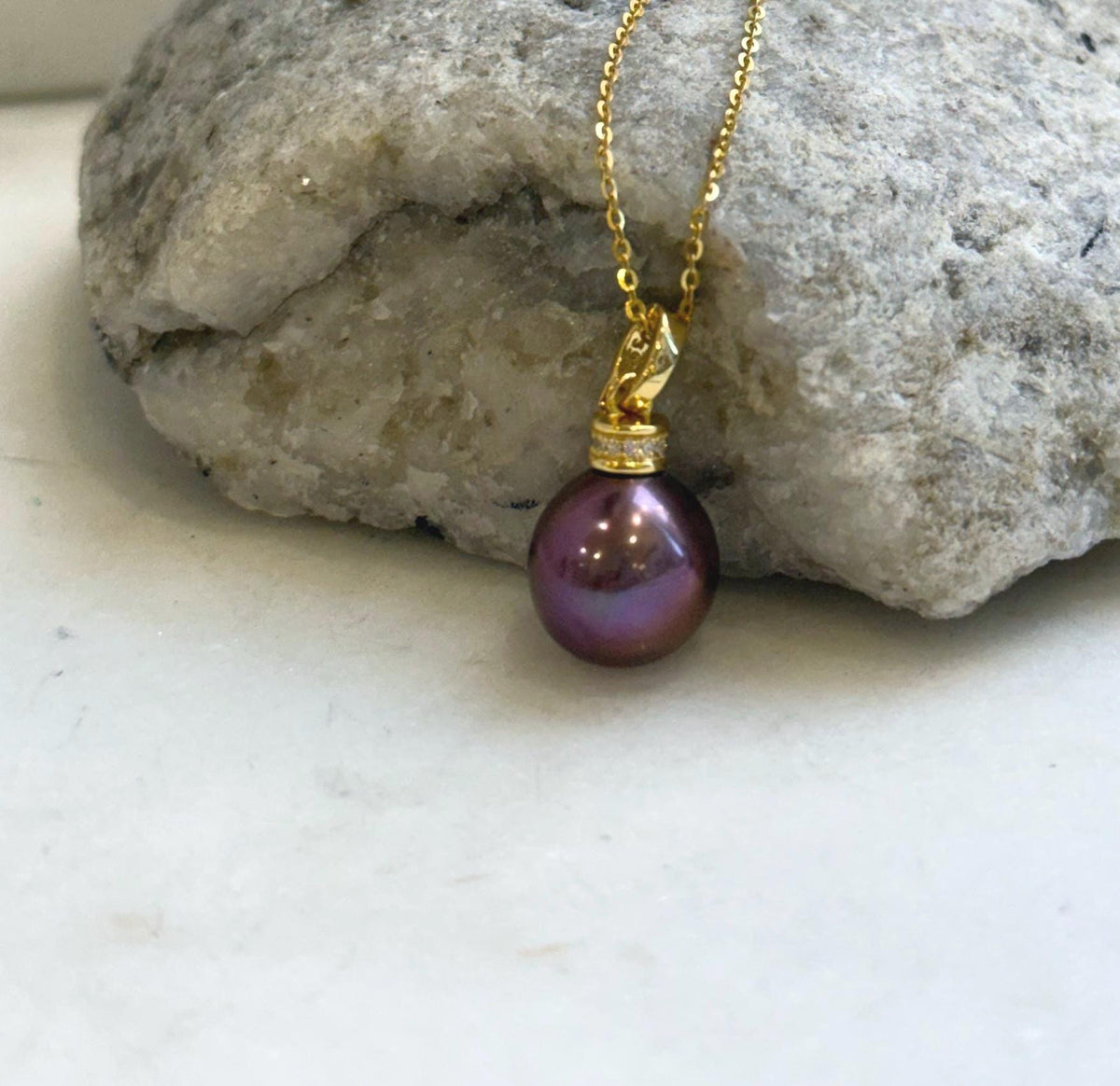 Rose raspberry pearl necklace and hook earrings with reflective surfaces.