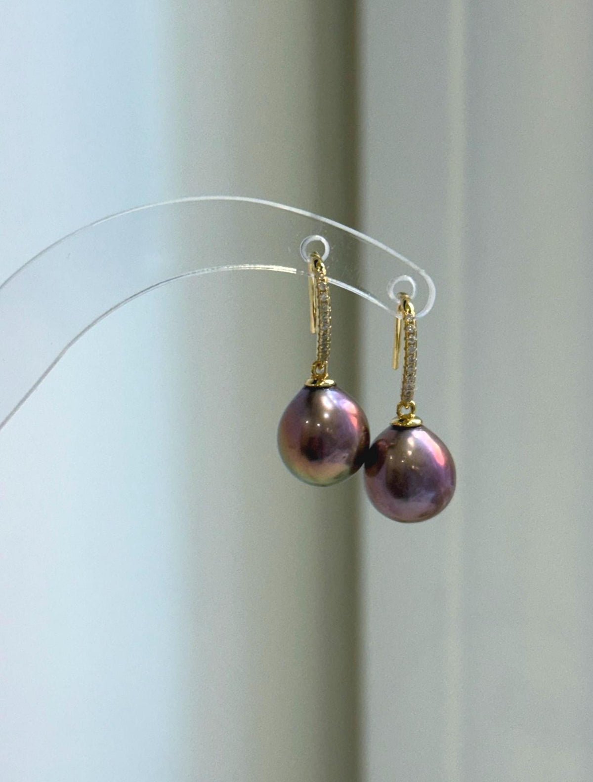 Lustrous raspberry rose pearls form the focal points of this necklace and earring set.