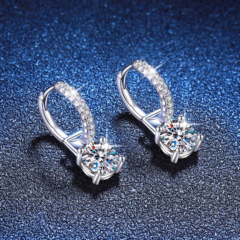 Pair of silver drop earrings with four-prong set round moissanite stones
