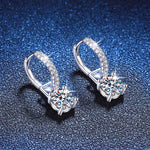 Pair of silver drop earrings with four-prong set round moissanite stones